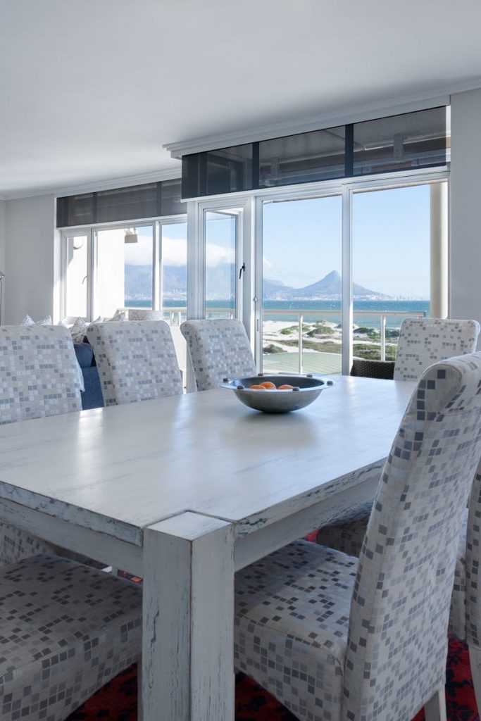 Luxurious dining room in Cape Town with modern furniture and ocean views.