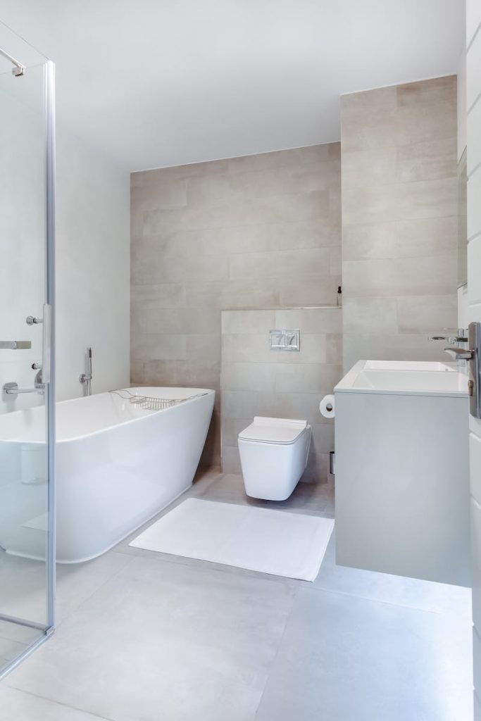Elegant minimalistic bathroom featuring bathtub and sleek fixtures.